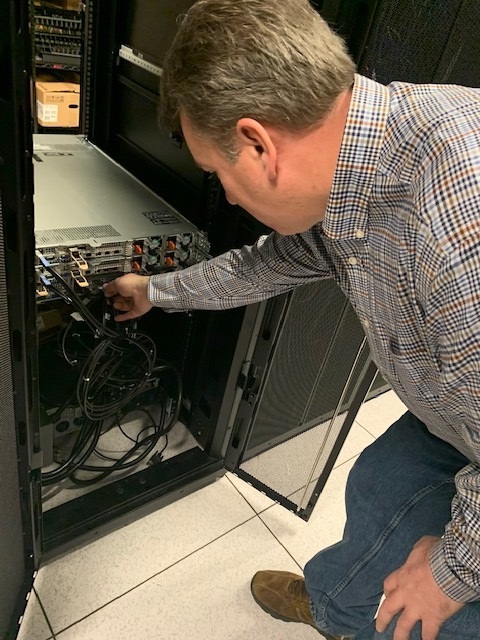 Technician inspecting server equipment in a data center