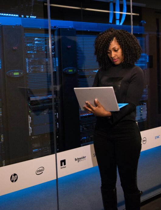 Data center staff monitoring systems in a control room